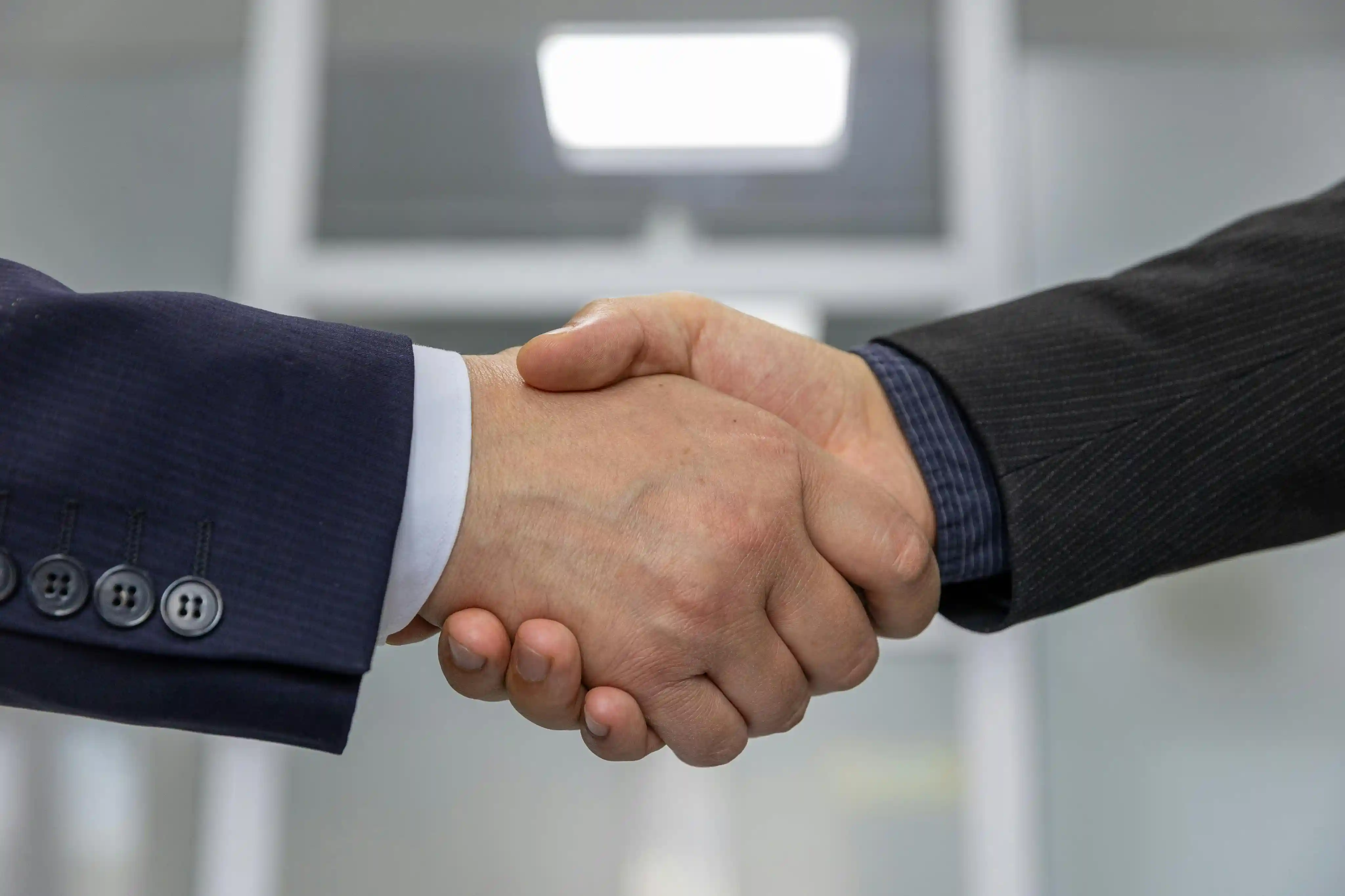 Partners shaking hands to build a strong character and future together